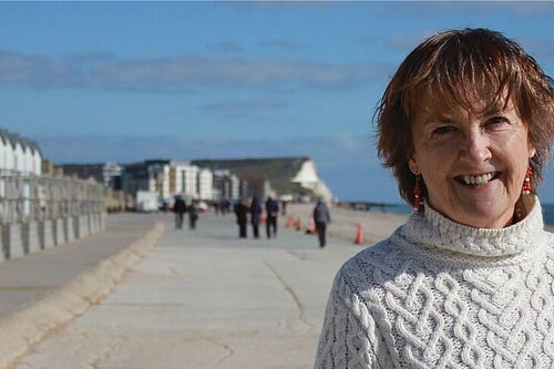 Head and shoulders shot of Councillor Carolyn Lambert with Seaford beach in the background