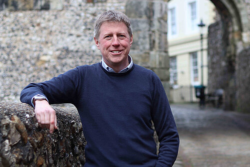 James MacCleary standing in front of the entrance to Lewes Castle and looking very relaxed.
