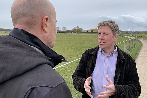 James talking with open fields behind him