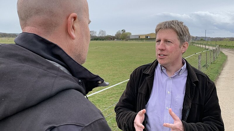 James talking with open fields behind him