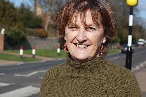 Head and shoulders shot of Councillor Carolyn Lambert with a pedestrian crossing in the background