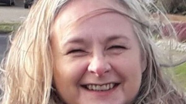 Portrait shot of Lesley Boniface smiling into the camera, with shoulder length fair hair.