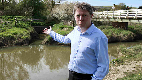James gesturing towards the sewage filled stream at Cuckmere Point