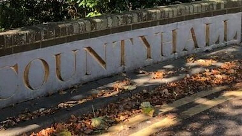 Imposing gold lettering on stone outside East Sussex County Council offices, reads "County Hall2.